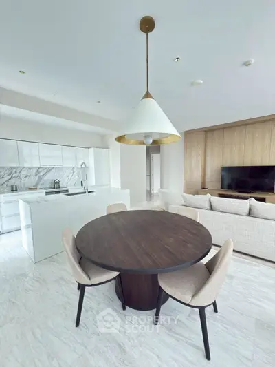 Modern open-plan living room with sleek kitchen and stylish dining area