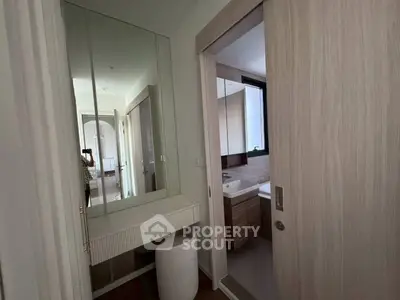 Modern bathroom with sleek design and mirrored vanity in a contemporary home.