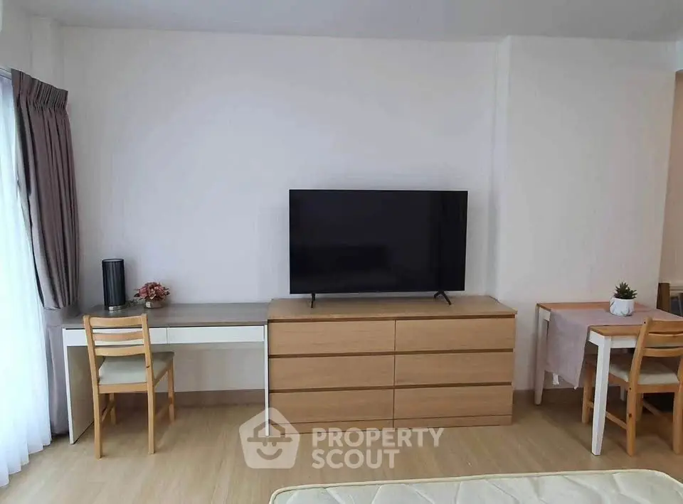 Modern living room with sleek TV setup and minimalist furniture design.