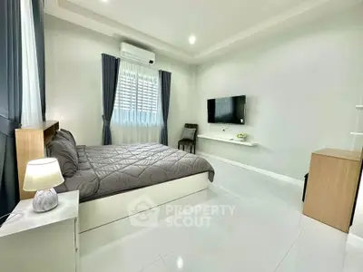 Spacious modern bedroom with sleek design and natural light