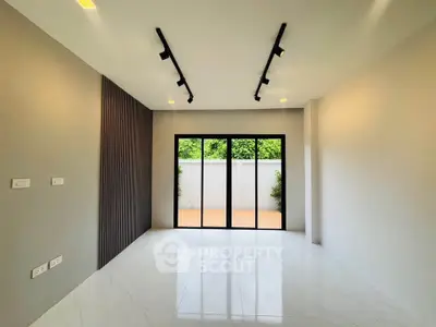 Spacious modern living room with large windows and sleek design.