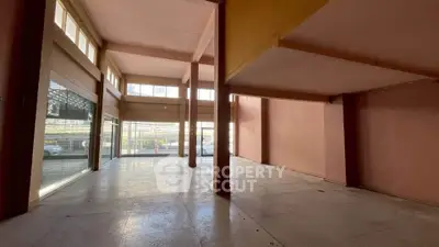 Spacious commercial property with large windows and high ceilings, ideal for retail or office space.