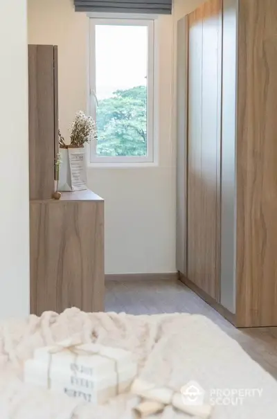 Cozy bedroom with wooden furniture and a scenic window view