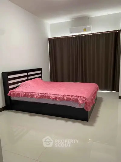 Spacious bedroom with modern bed and elegant curtains