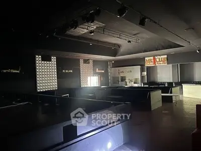 Spacious nightclub interior with modern design and ambient lighting.