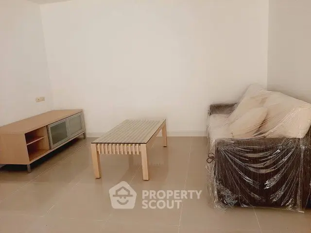 Minimalist living room with modern furniture and tiled flooring, perfect for a cozy home setup.