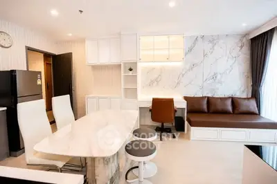 Modern open-layout living room with marble accents and stylish furniture