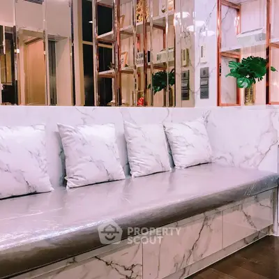 Luxurious marble-themed interior with plush seating and elegant decor