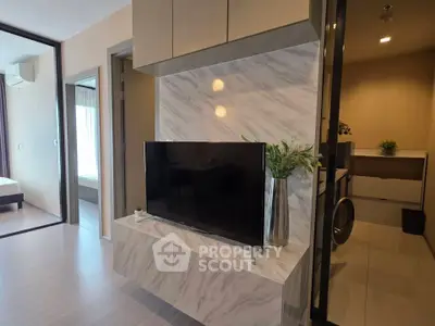 Modern living room with marble TV wall and sleek decor in a stylish apartment.