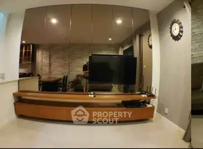 Modern living room with sleek TV stand and mirrored wall