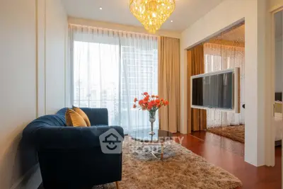 Luxurious living room with elegant chandelier and modern decor in high-rise apartment