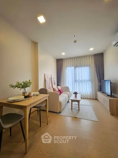 Modern living room with cozy sofa, dining table, and large window in stylish apartment.