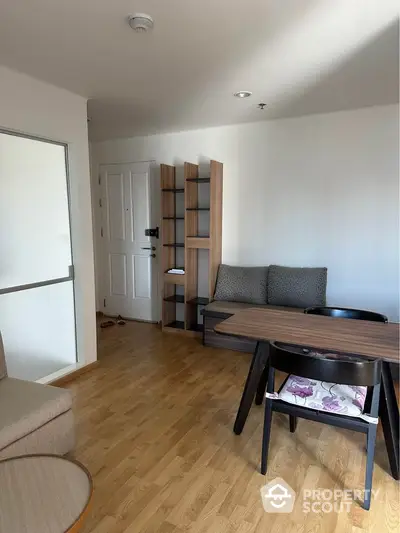 Cozy living room with modern furniture and wooden flooring in a stylish apartment.