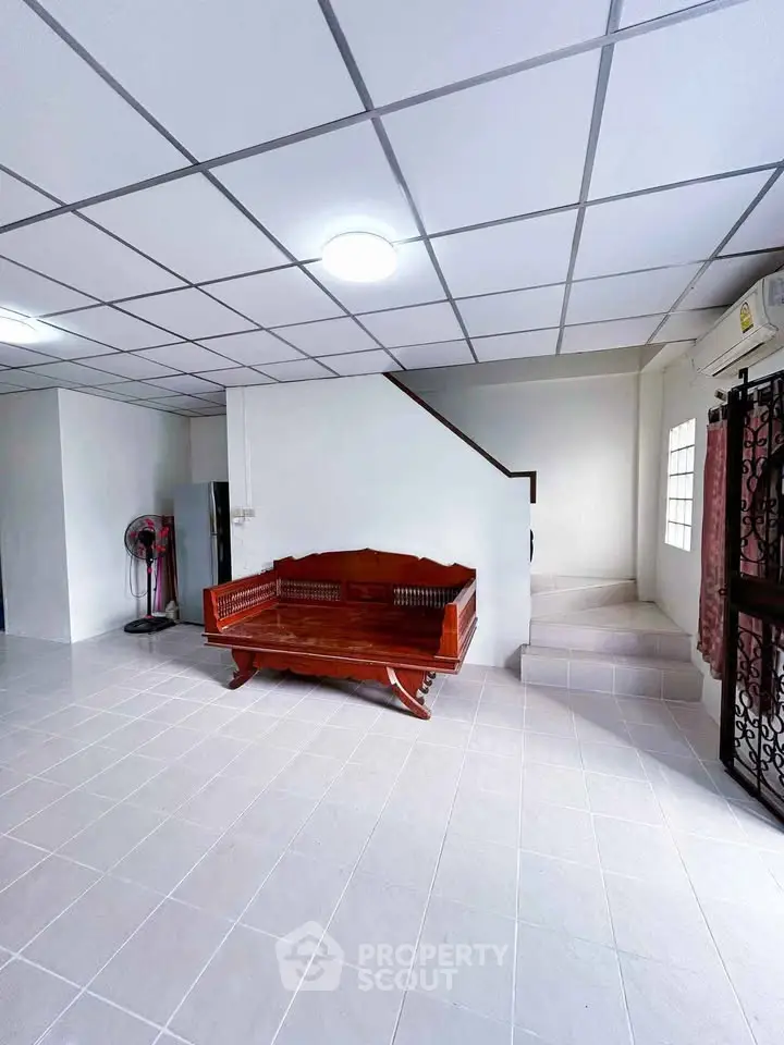 Spacious interior with modern tiled flooring and elegant wooden furniture