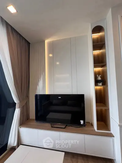 Modern living room with sleek TV unit and stylish shelving