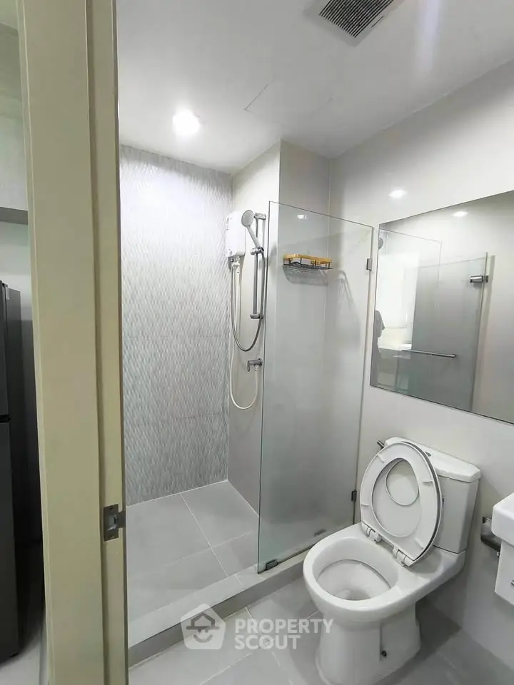 Modern bathroom with glass shower enclosure and sleek fixtures