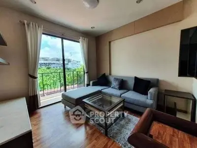 Bright living room with modern sofa and balcony view, perfect for relaxation.