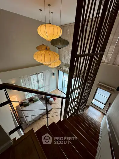 Modern duplex interior with stylish lighting and wooden staircase