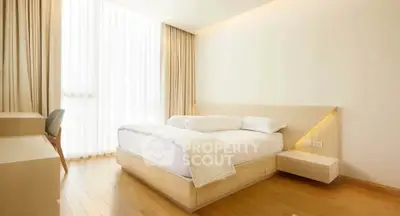 Modern minimalist bedroom with natural light and wooden flooring