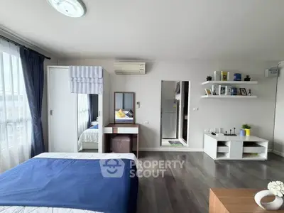 Spacious modern bedroom with stylish decor and ample natural light