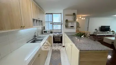 Spacious open kitchen with modern appliances and city view, perfect for culinary enthusiasts.