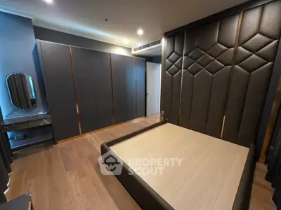 Luxurious modern bedroom with elegant wood flooring and stylish wall paneling