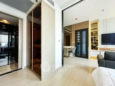 Modern living room with sleek design and open layout, featuring stylish furniture and elegant decor.