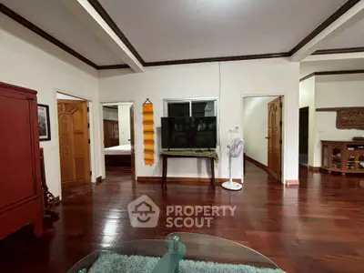 Spacious living room with hardwood floors and elegant furnishings
