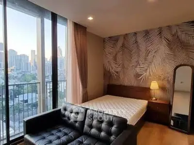 Stylish bedroom with city view, modern decor, and cozy furnishings.
