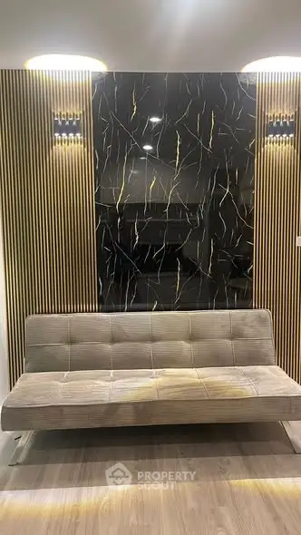 Modern living room with stylish sofa and elegant wall design