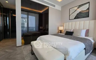 Luxurious modern bedroom with elegant decor and large windows offering natural light.