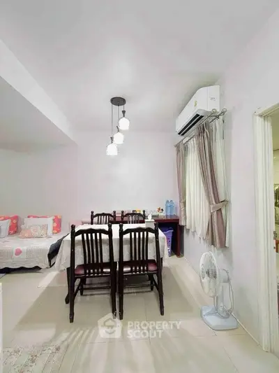Charming dining area with elegant lighting and air conditioning, perfect for cozy family meals.