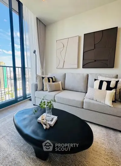 Modern living room with stylish decor and city view balcony