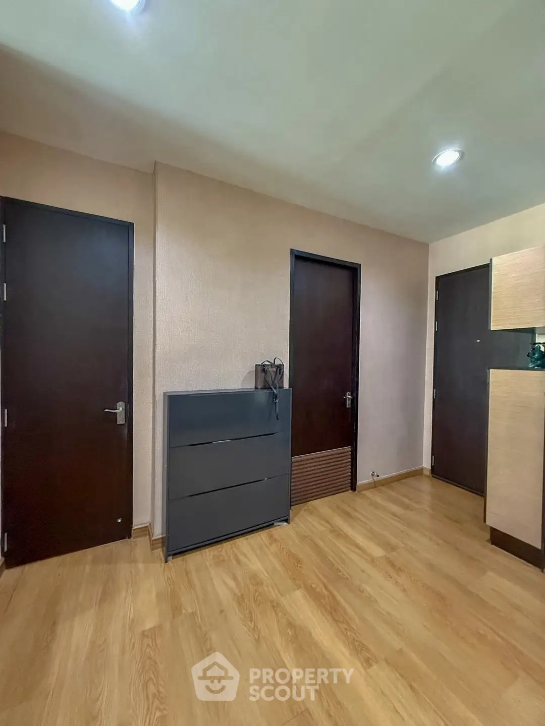 Modern interior with wooden flooring and sleek black furniture in a cozy room.