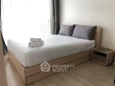 Modern bedroom with wooden bed frame and natural light