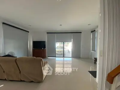 Spacious living room with modern decor and large windows for natural light.