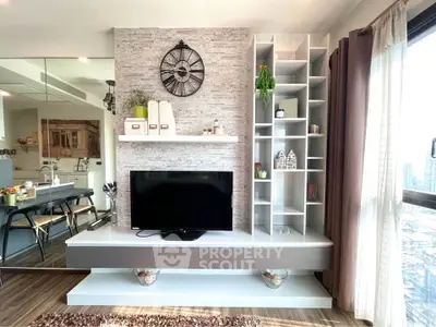 Modern living room with stylish TV unit and open shelving, featuring a chic wall clock and bright decor.