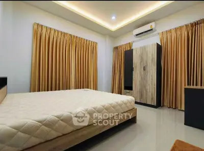 Spacious bedroom with modern design and elegant lighting, featuring a large bed and ample storage space.