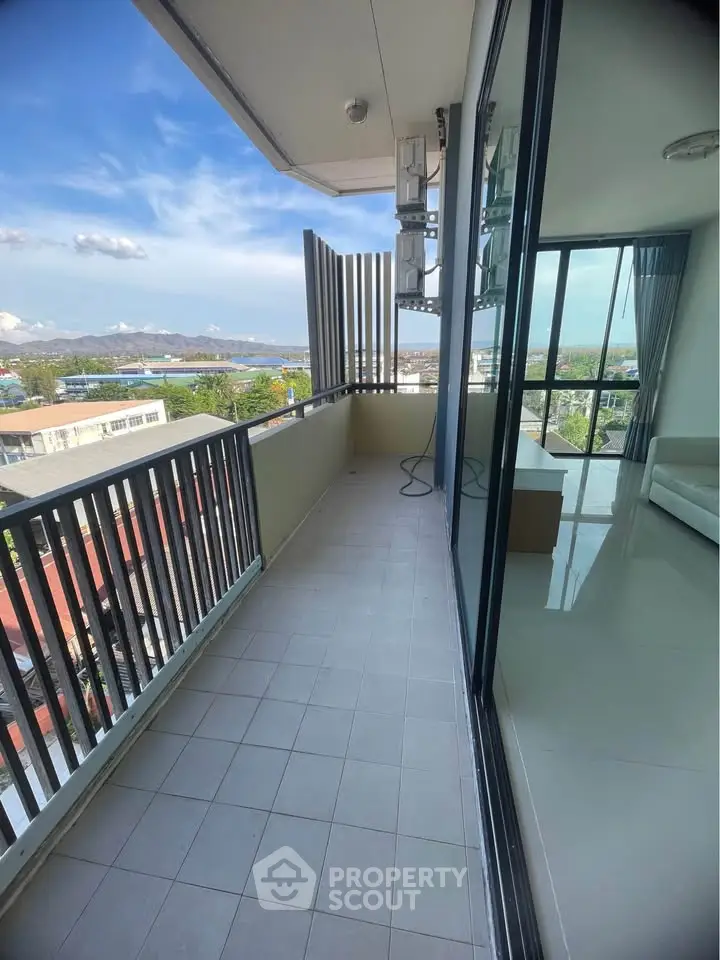 Spacious balcony with stunning city view and modern glass sliding doors.