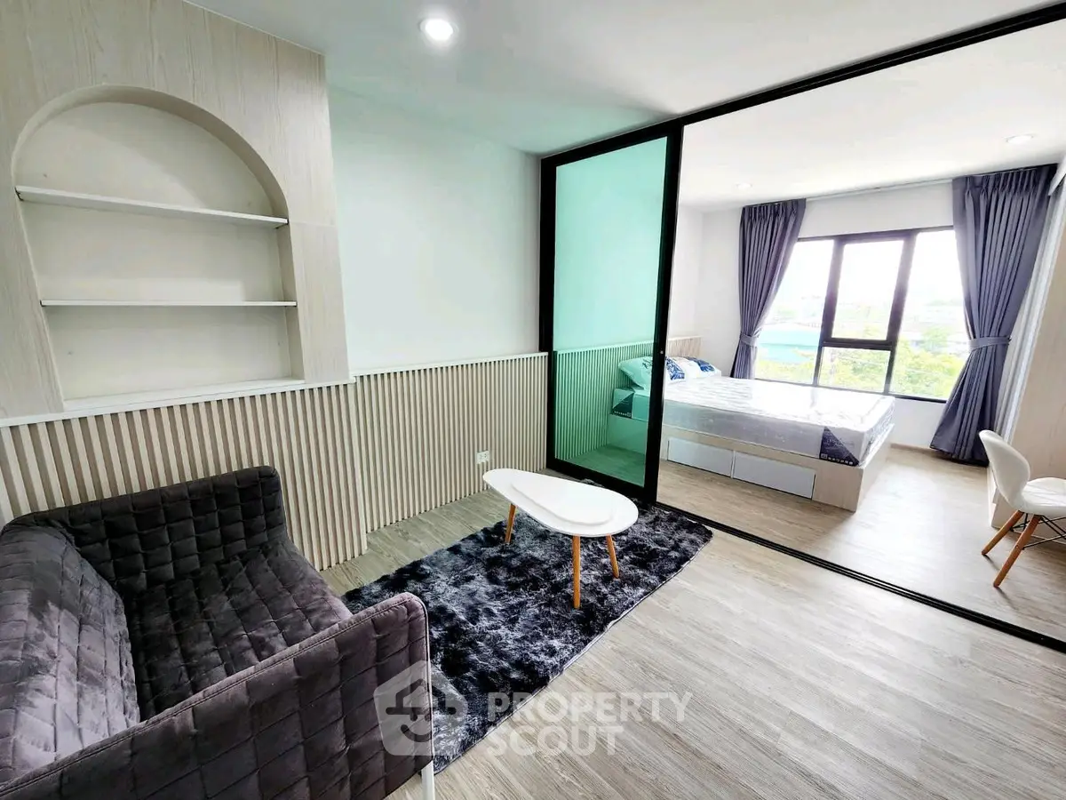 Modern apartment with stylish living room and cozy bedroom, featuring large windows and elegant decor.