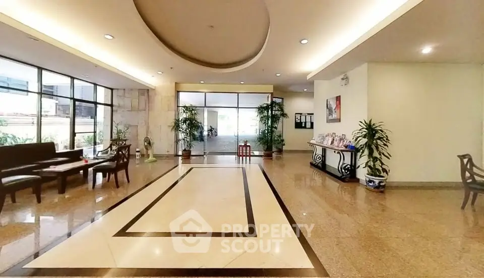 Elegant building entrance with modern decor and spacious lobby area.