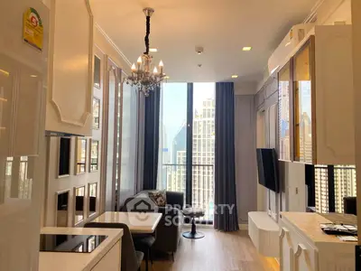 Luxurious high-rise living room with stunning city view and elegant chandelier.