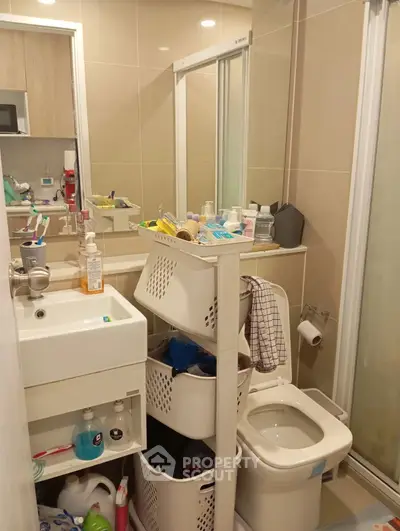 Compact bathroom with modern fixtures and ample storage solutions.