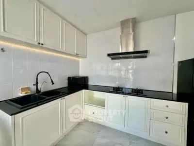 Modern kitchen with sleek black countertops and gas stove