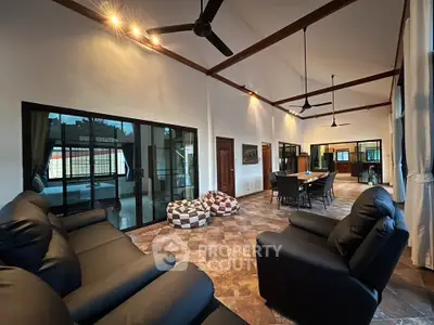 Spacious living room with high ceilings and modern furnishings in a luxurious home.