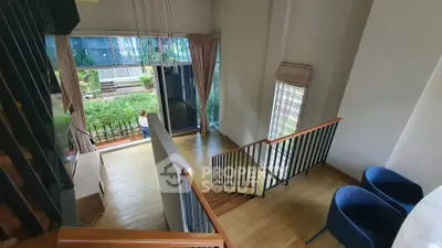 Spacious two-story living room with garden view and modern decor