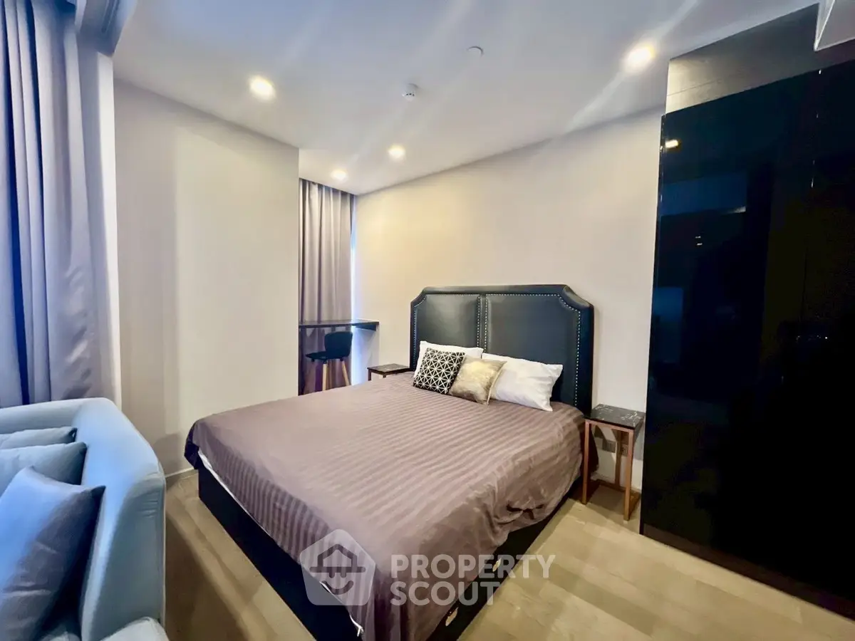 Modern bedroom with stylish decor and cozy ambiance, featuring a comfortable bed and elegant furnishings.