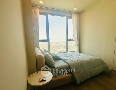 Cozy bedroom with panoramic city view and elegant decor