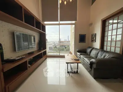 Spacious living room with high ceiling and city view, featuring modern furniture and large windows.