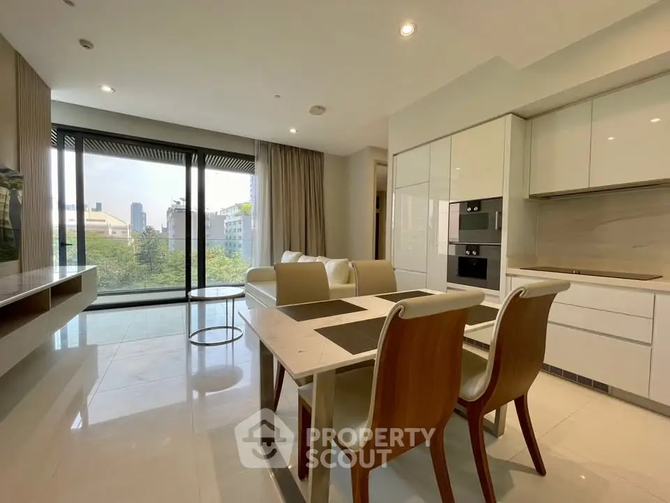 Modern open-plan living room with dining area and large windows offering city views.